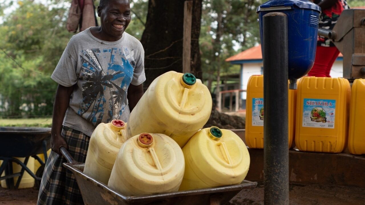 DSW Kenya woman wheeling water watermarked